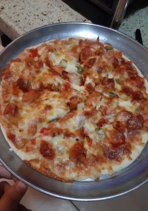 A picture of Chicken Tikka pizza.