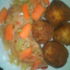 A picture of Potato fritters and fried cabbage.