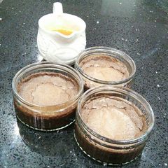 A picture of Chocolate Souffle With An Orange Syrup.