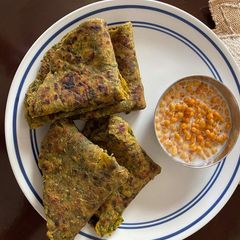 A picture of Palak paratha with Boondi Raita.