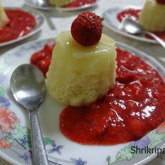 A picture of Lemon pudding cake with Fresh Strawberry Sauce.