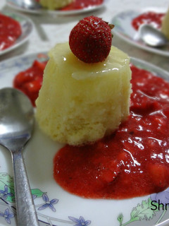 A picture of Lemon pudding cake with Fresh Strawberry Sauce.