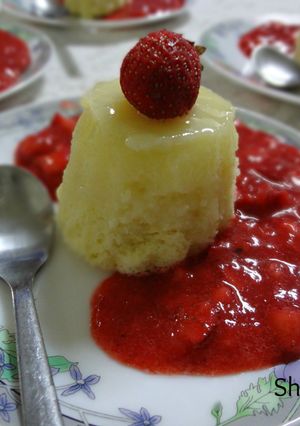 A picture of Lemon pudding cake with Fresh Strawberry Sauce.