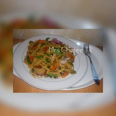 A picture of Jallof sphagetti with beans.
