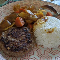 A picture of Japanese curry with beef patty.