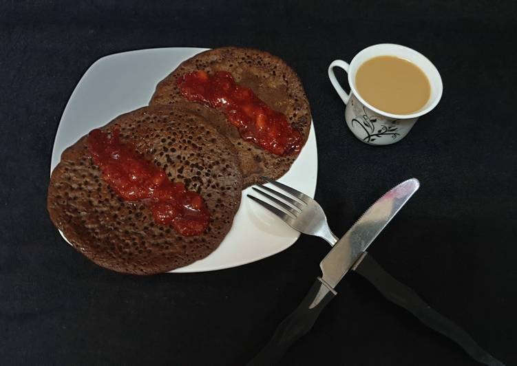 Chocolate pancake with strawberry sauce