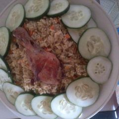 A picture of Fried rice and chicken.