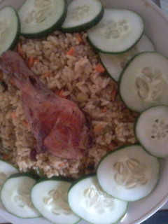 A picture of Fried rice and chicken.