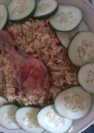 A picture of Fried rice and chicken.