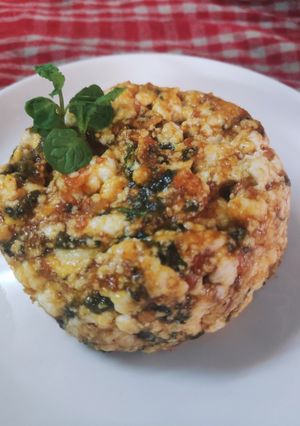 A picture of Crumbled cottage cheese in peanut butter sauce.