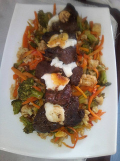 A picture of Fillet of steak with stir fried veggies.