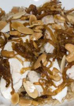 A picture of Fried fish and brown-colored rice - siyyadieh.