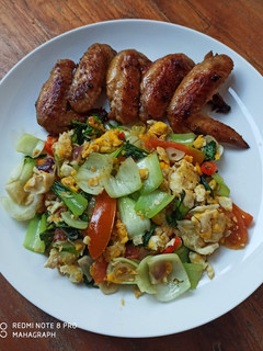 A picture of Pan Fried Chicken Wings and Stir Fry Bok Choi with Scrambled Eggs.