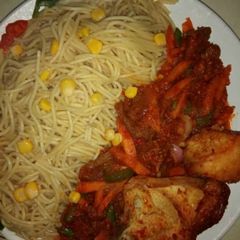 A picture of Spagetti with corn.