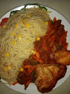 A picture of Spagetti with corn.