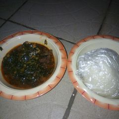 A picture of Pounded yam with vegetable and bitter leaf.