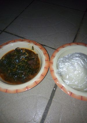 A picture of Pounded yam with vegetable and bitter leaf.