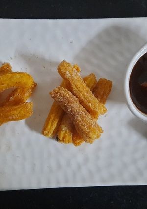 A picture of Churros with chocolate dip.