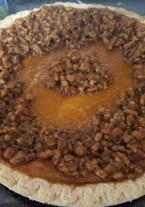 A picture of The best sweet potato pie with pecan topping.