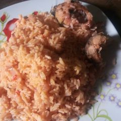 A picture of Jollof rice with boiled fish.