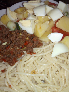 A picture of Spaghetti, minced meat sauce and potato salad.