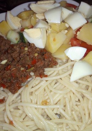A picture of Spaghetti, minced meat sauce and potato salad.