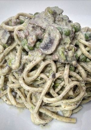A picture of Tagliolini with Truffle, Mushrooms, Peas, and Sausage.
