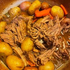 A picture of Pot roast in a Dutch oven.