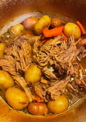 A picture of Pot roast in a Dutch oven.