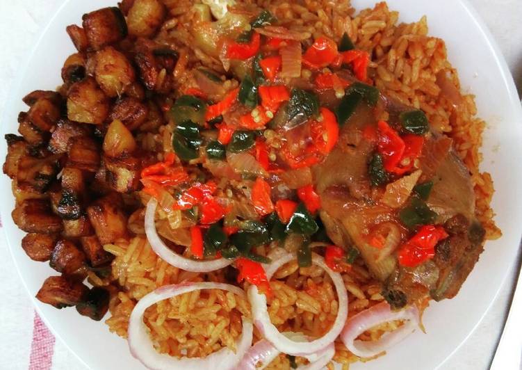 Jollof rice and fried chicken sauce garnished with plantain