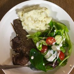 A picture of Grilled Lamb chops, mashed potatoes and salad.