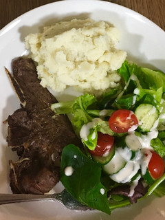 A picture of Grilled Lamb chops, mashed potatoes and salad.