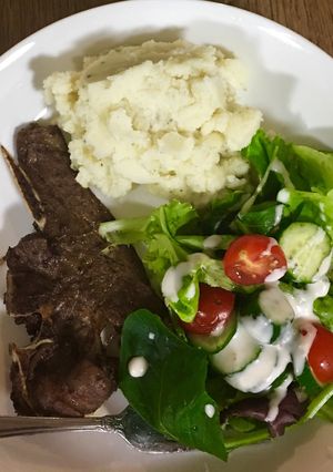 A picture of Grilled Lamb chops, mashed potatoes and salad.