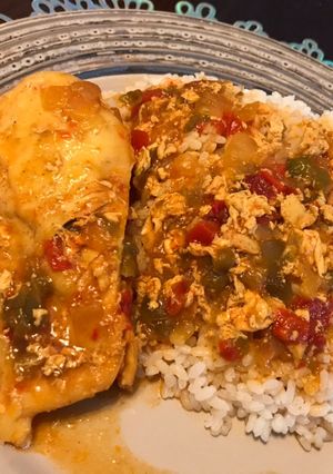 A picture of White Rice with Chicken Breast in Sauce.