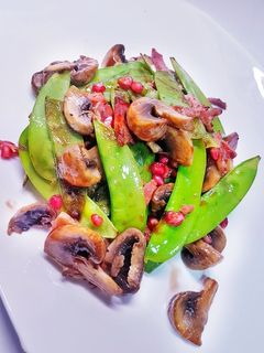 Una foto de Tirabeques salteados en salsa de ostras y granada