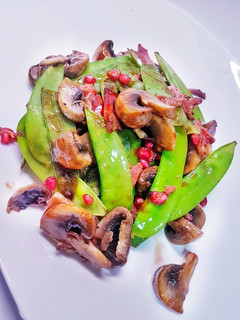 Una foto de Tirabeques salteados en salsa de ostras y granada