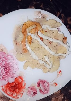 A picture of Plain white sauce pasta 🍝 with fries 🍟.
