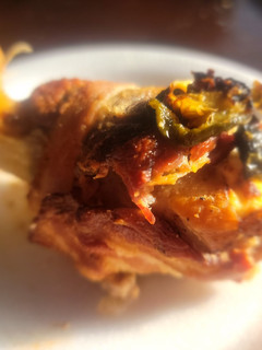 A picture of Bacon & Sirloin Wrapped, Cream Cheese Stuffed Chicken Legs.