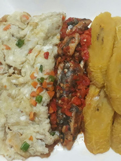 A picture of Ripe plantain with fried egg and peppered sardine.