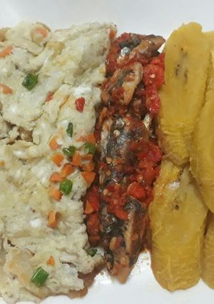 A picture of Ripe plantain with fried egg and peppered sardine.