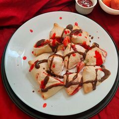 A picture of Strawberry Stuffed Baked Samosa with Chocolate Ganache.