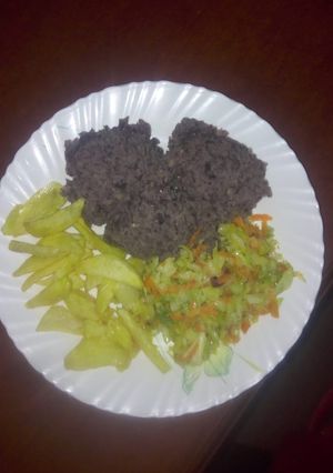A picture of Sweet Smashed njahi and banana with steamed cabbage and fries.