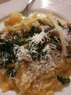 A picture of Butternut squash creamy pasta with kale & bacon topping.