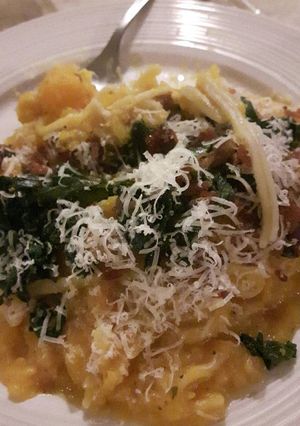 A picture of Butternut squash creamy pasta with kale & bacon topping.