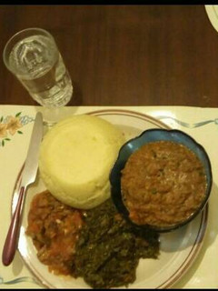 A picture of AfricanCake(Ugali)Sauted mushroomsKenyan greens by Seline.