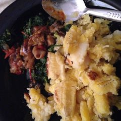 A picture of Matoke served with matumbo and spinach.