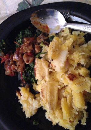 A picture of Matoke served with matumbo and spinach.