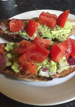 A picture of Avocado and tomato breakfast sandwich.