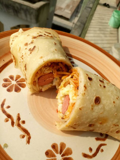 A picture of Beef, hot dog and vegetable crepe.