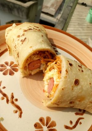 A picture of Beef, hot dog and vegetable crepe.